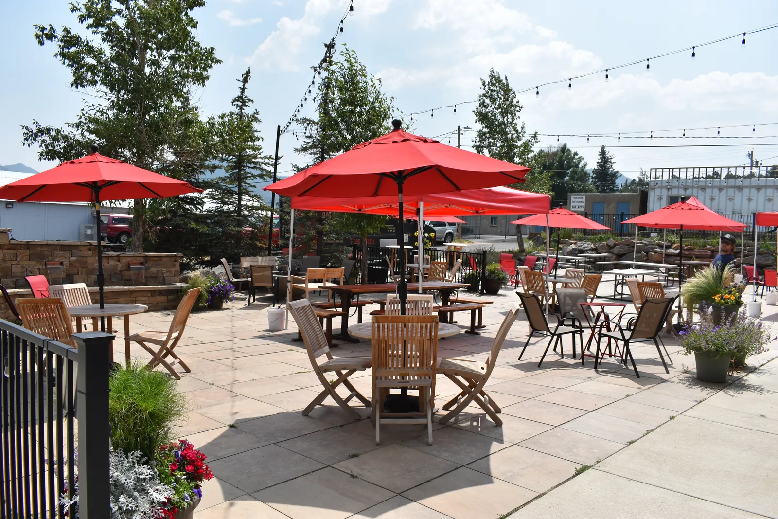 Avant Garde outdoor beer garden patio seating with red umbrellas